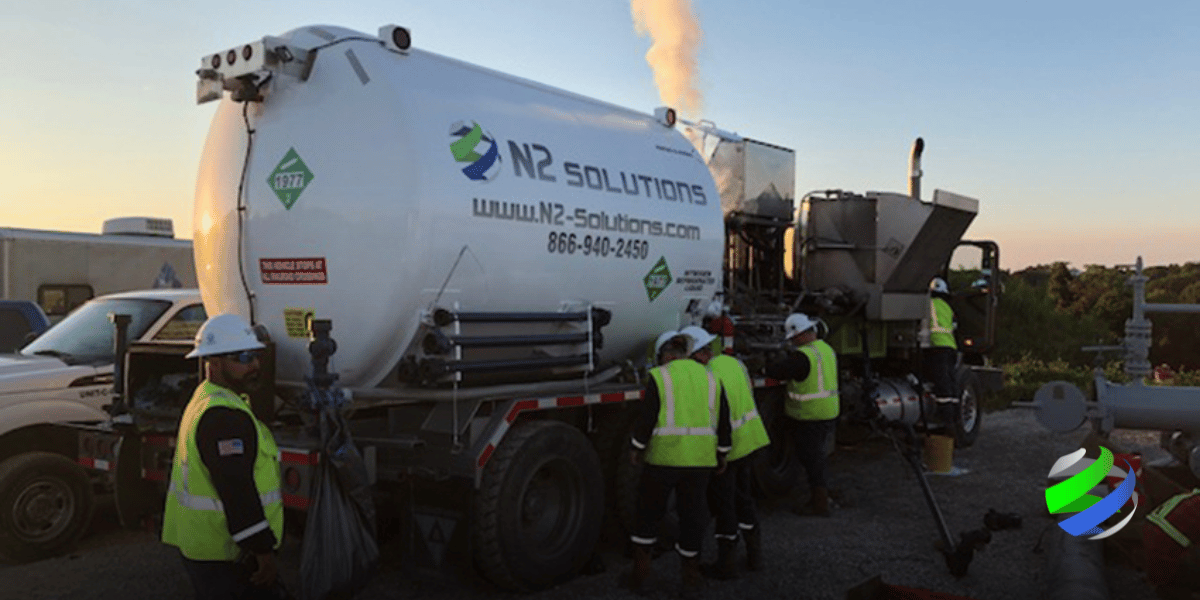 Men working on a job site with N2 Solution's truck